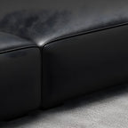 Extra Long Black Leather Sofa with Stain Resistant Feature and Two Pillows