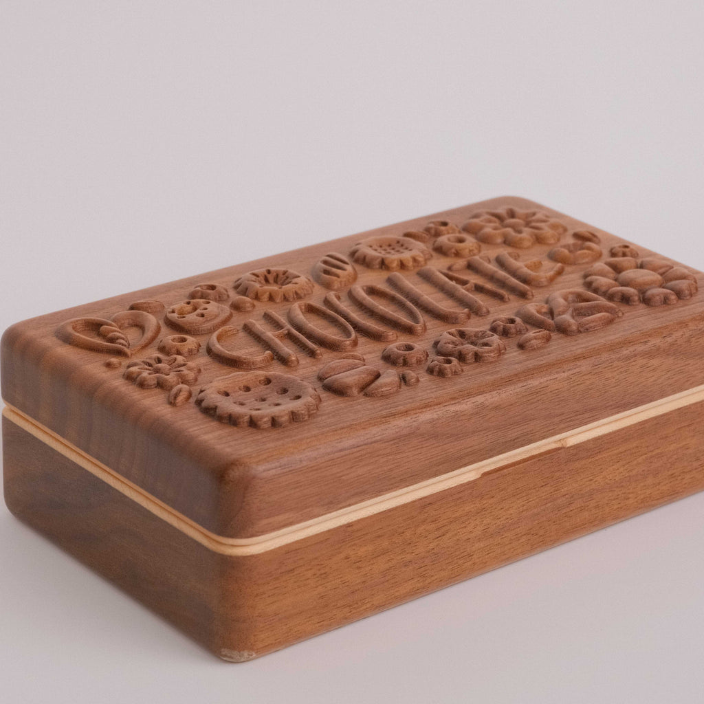 Close-up of Coco carved chocolate lid