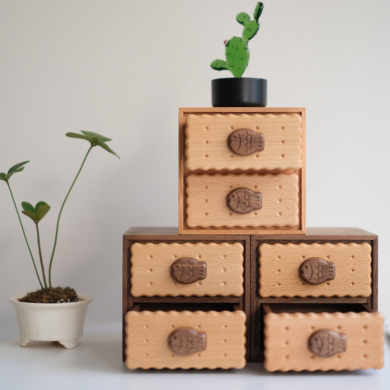 Oudine biscuit-drawer cabinets arranged with plants