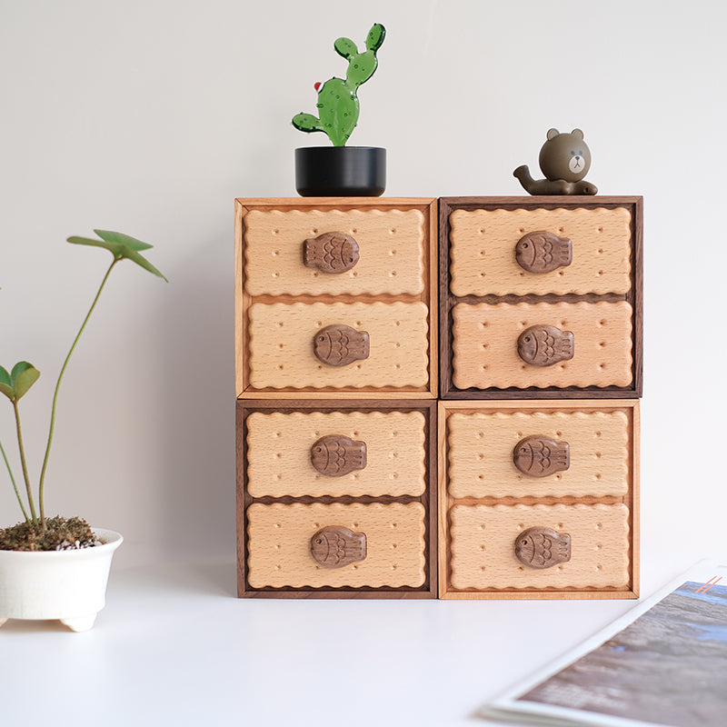 Four Oudine drawers arranged as a square