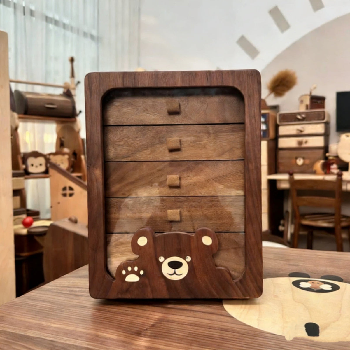 Front view of the Peoria walnut jewelry cabinet with bear-shaped panel
