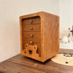 Peoria cherry rotating jewelry cabinet with four drawers and bear detail