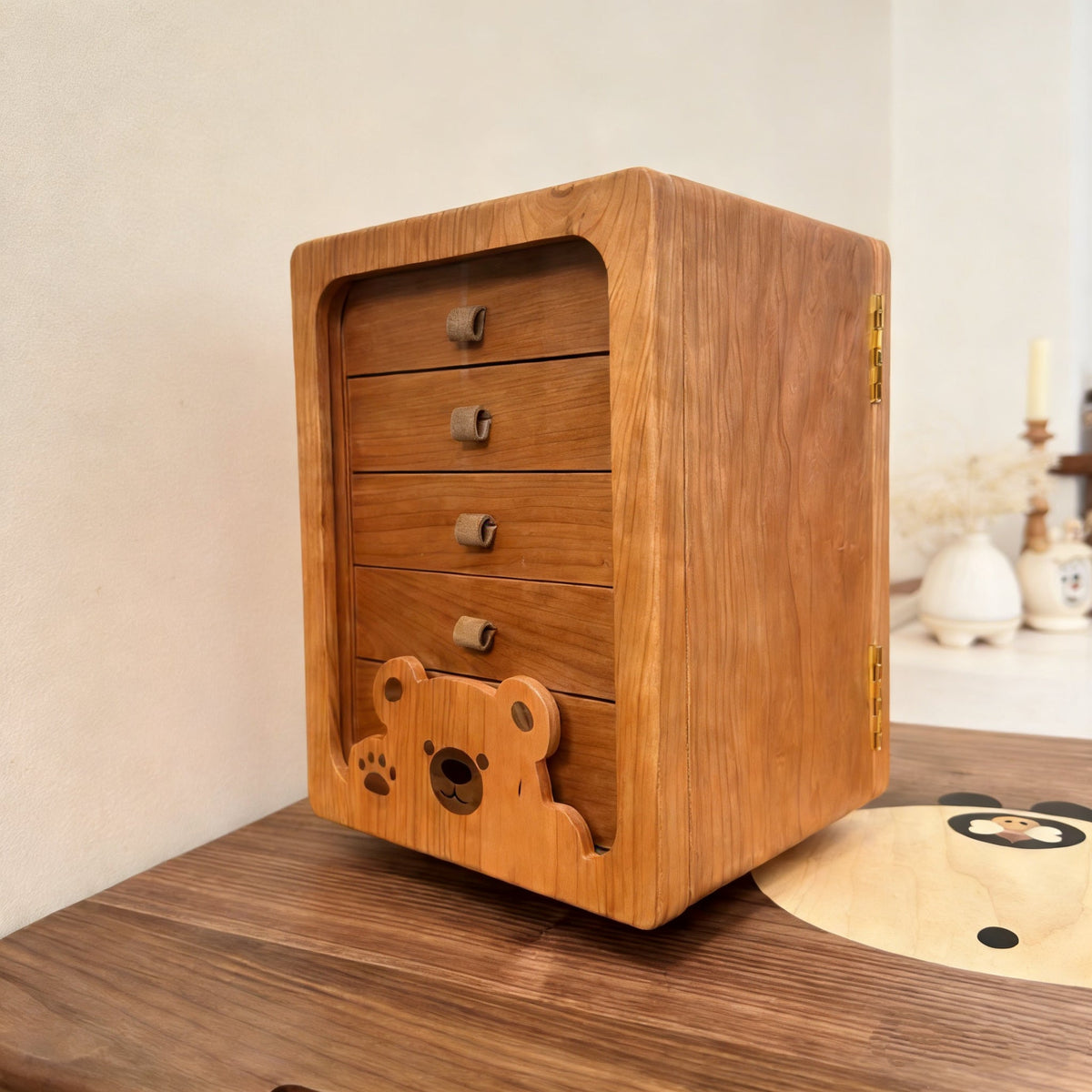 Peoria cherry rotating jewelry cabinet with four drawers and bear detail