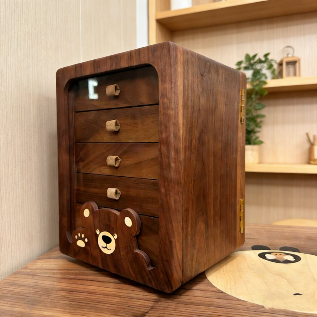 Peoria walnut rotating jewelry cabinet with four drawers and bear detail