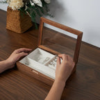 Hands placing jewelry in an open Giselle box