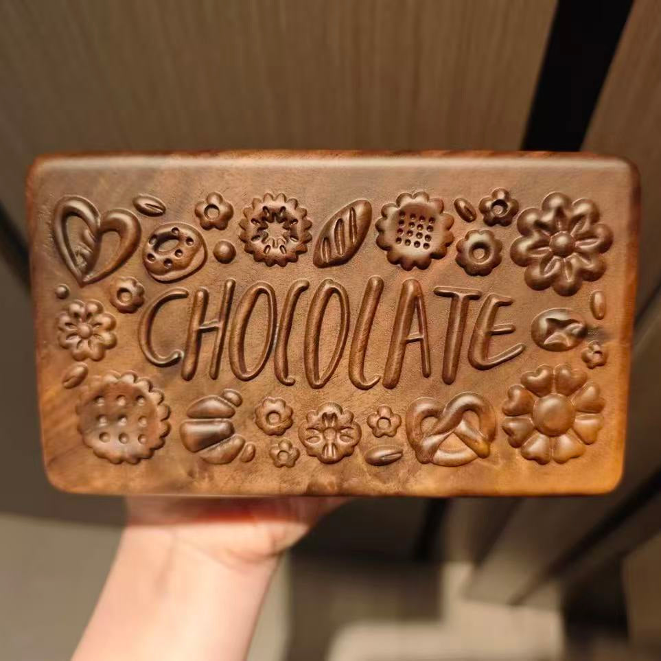 Hand holding the carved Coco jewelry box lid