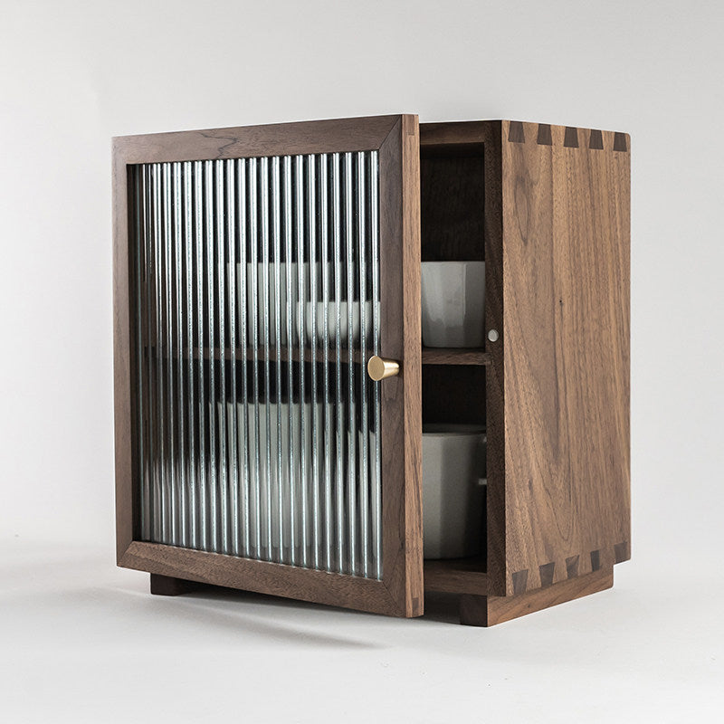 Agni walnut cabinet with fluted glass door three-quarter view