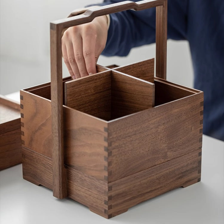 Hand carrying the Clef walnut storage caddy