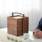 Clef walnut storage caddy beside a tea setting