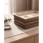 Three walnut jewelry trays stacked flush on a dresser, about three inches tall in total