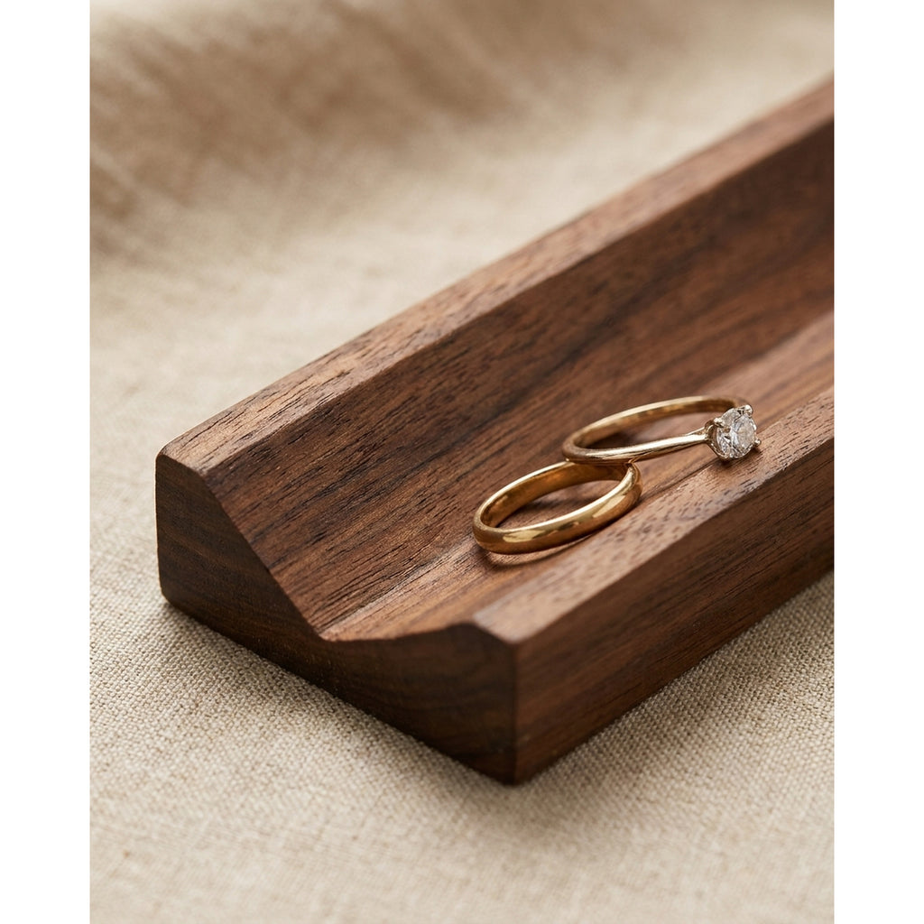 Walnut ring slot holder corner with two gold rings resting in the slot